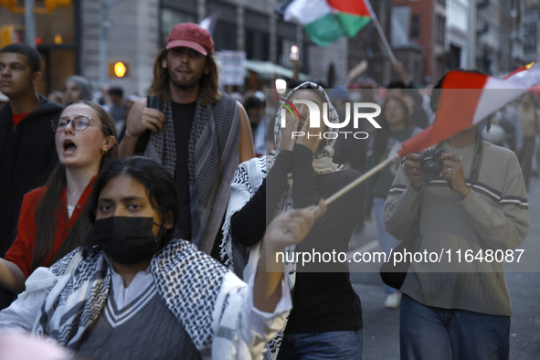 Palestinian supporters march through the streets with flags and signs against the October 2023 Israeli incursion of Gaza, on October 7, 2024...