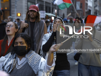 Palestinian supporters march through the streets with flags and signs against the October 2023 Israeli incursion of Gaza, on October 7, 2024...