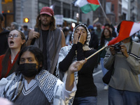 Palestinian supporters march through the streets with flags and signs against the October 2023 Israeli incursion of Gaza, on October 7, 2024...