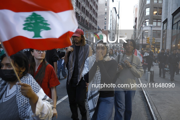 Palestinian supporters march through the streets with flags and signs against the October 2023 Israeli incursion of Gaza, on October 7, 2024...