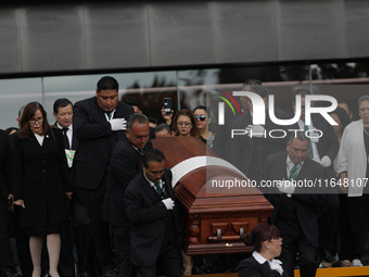 Persons carry a coffin with the body of Ifigenia Martinez during the posthumous funeral tribute in honor of Ifigenia Martinez, 99, in the Ch...