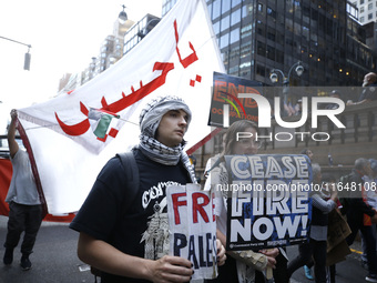 Palestinian supporters march through the streets with flags and signs against the October 2023 Israeli incursion of Gaza, on October 7, 2024...