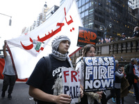 Palestinian supporters march through the streets with flags and signs against the October 2023 Israeli incursion of Gaza, on October 7, 2024...