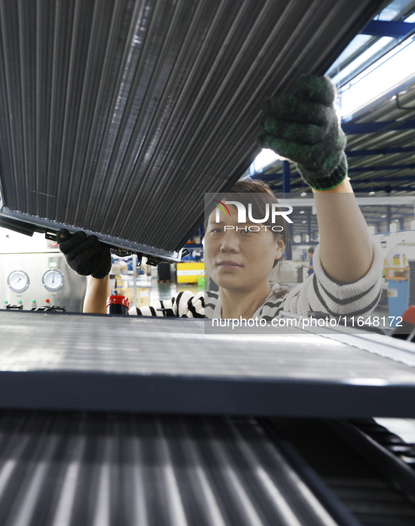 A worker works at the production workshop of Jiangsu Xinhua Auto Parts Co LTD in Sihong Economic Development Zone in Suqian, Jiangsu provinc...