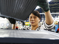 A worker works at the production workshop of Jiangsu Xinhua Auto Parts Co LTD in Sihong Economic Development Zone in Suqian, Jiangsu provinc...