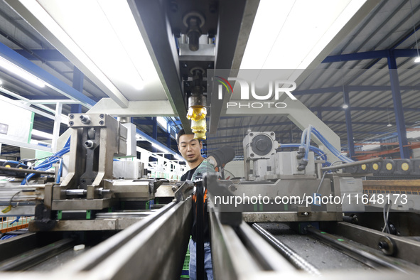 A worker works at the production workshop of Jiangsu Xinhua Auto Parts Co LTD in Sihong Economic Development Zone in Suqian, Jiangsu provinc...