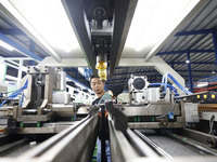 A worker works at the production workshop of Jiangsu Xinhua Auto Parts Co LTD in Sihong Economic Development Zone in Suqian, Jiangsu provinc...