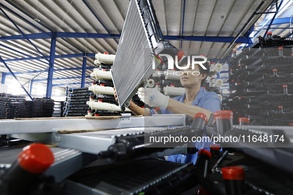 A worker works at the production workshop of Jiangsu Xinhua Auto Parts Co LTD in Sihong Economic Development Zone in Suqian, Jiangsu provinc...