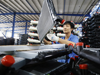 A worker works at the production workshop of Jiangsu Xinhua Auto Parts Co LTD in Sihong Economic Development Zone in Suqian, Jiangsu provinc...