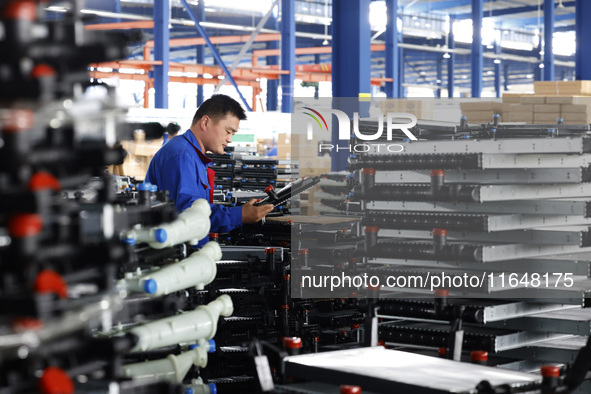 A worker works at the production workshop of Jiangsu Xinhua Auto Parts Co LTD in Sihong Economic Development Zone in Suqian, Jiangsu provinc...