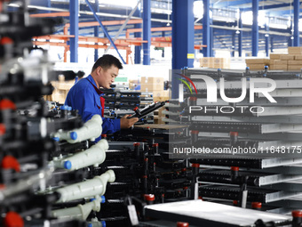 A worker works at the production workshop of Jiangsu Xinhua Auto Parts Co LTD in Sihong Economic Development Zone in Suqian, Jiangsu provinc...