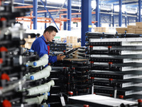 A worker works at the production workshop of Jiangsu Xinhua Auto Parts Co LTD in Sihong Economic Development Zone in Suqian, Jiangsu provinc...