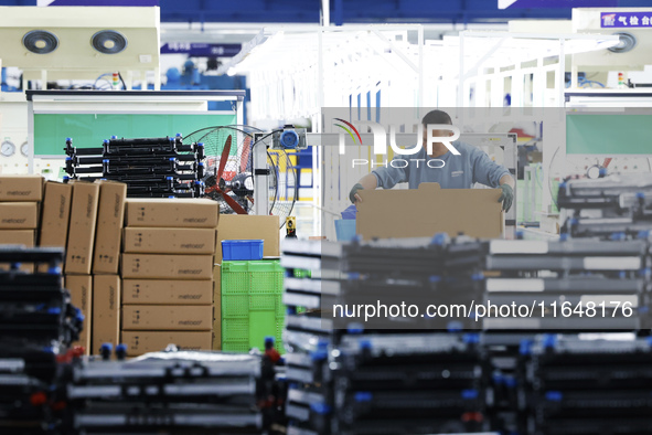 A worker works at the production workshop of Jiangsu Xinhua Auto Parts Co LTD in Sihong Economic Development Zone in Suqian, Jiangsu provinc...