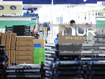 A worker works at the production workshop of Jiangsu Xinhua Auto Parts Co LTD in Sihong Economic Development Zone in Suqian, Jiangsu provinc...