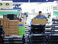 A worker works at the production workshop of Jiangsu Xinhua Auto Parts Co LTD in Sihong Economic Development Zone in Suqian, Jiangsu provinc...