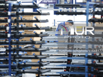 A worker works at the production workshop of Jiangsu Xinhua Auto Parts Co LTD in Sihong Economic Development Zone in Suqian, Jiangsu provinc...