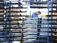 A worker works at the production workshop of Jiangsu Xinhua Auto Parts Co LTD in Sihong Economic Development Zone in Suqian, Jiangsu provinc...