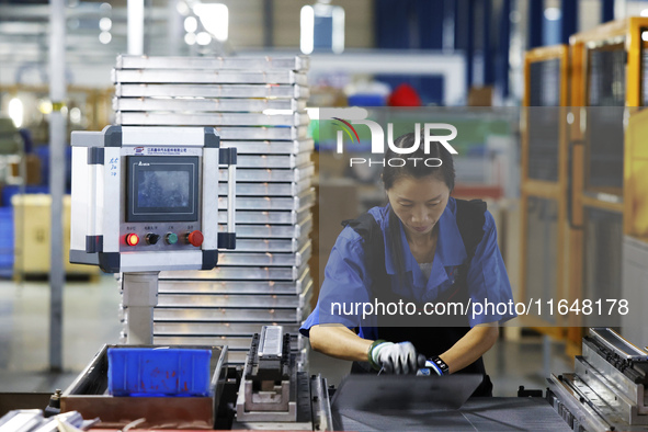 A worker works at the production workshop of Jiangsu Xinhua Auto Parts Co LTD in Sihong Economic Development Zone in Suqian, Jiangsu provinc...