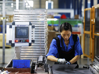 A worker works at the production workshop of Jiangsu Xinhua Auto Parts Co LTD in Sihong Economic Development Zone in Suqian, Jiangsu provinc...