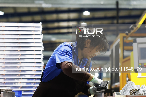 A worker works at the production workshop of Jiangsu Xinhua Auto Parts Co LTD in Sihong Economic Development Zone in Suqian, Jiangsu provinc...