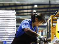 A worker works at the production workshop of Jiangsu Xinhua Auto Parts Co LTD in Sihong Economic Development Zone in Suqian, Jiangsu provinc...