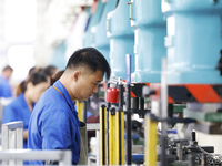 Workers work at the production workshop of Jiangsu Xinhua Auto Parts Co LTD in Sihong Economic Development Zone in Suqian, Jiangsu province,...