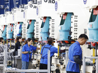 Workers work at the production workshop of Jiangsu Xinhua Auto Parts Co LTD in Sihong Economic Development Zone in Suqian, Jiangsu province,...