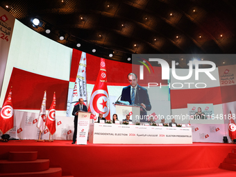 The head of the Tunisian election commission, Farouk Bouasker, along with other members of the Tunisian election commission, gives a press c...