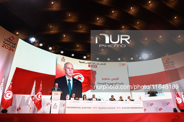 The head of the Tunisian election commission, Farouk Bouasker, along with other members of the Tunisian election commission, gives a press c...