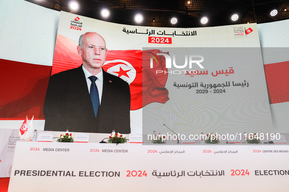 A giant screen displays a national flag of Tunisia with a portrait of Tunisia's president, Kais Saied, and the text in Arabic, ''Kais Saied...