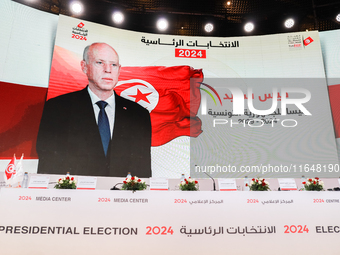 A giant screen displays a national flag of Tunisia with a portrait of Tunisia's president, Kais Saied, and the text in Arabic, ''Kais Saied...