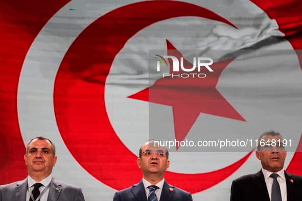 The head of the Tunisian election commission, Farouk Bouasker, along with other members of the Tunisian election commission, sings Tunisia's...