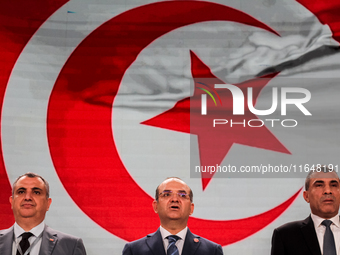 The head of the Tunisian election commission, Farouk Bouasker, along with other members of the Tunisian election commission, sings Tunisia's...