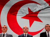 The head of the Tunisian election commission, Farouk Bouasker, along with other members of the Tunisian election commission, sings Tunisia's...