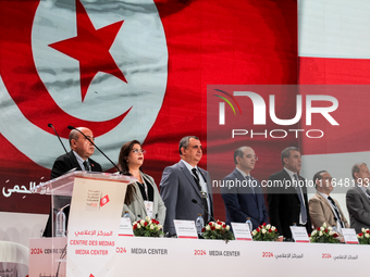 The head of the Tunisian election commission, Farouk Bouasker, along with other members of the Tunisian election commission, sings Tunisia's...