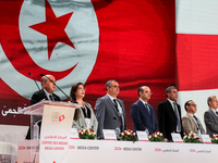 The head of the Tunisian election commission, Farouk Bouasker, along with other members of the Tunisian election commission, sings Tunisia's...