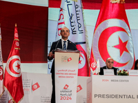 The head of the Tunisian election commission, Farouk Bouasker, along with other members of the Tunisian election commission, gives a press c...