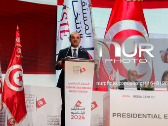 The head of the Tunisian election commission, Farouk Bouasker, along with other members of the Tunisian election commission, gives a press c...