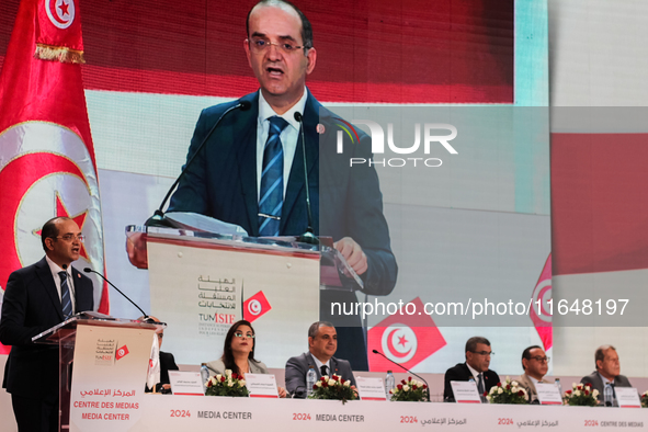 The head of the Tunisian election commission, Farouk Bouasker, along with other members of the Tunisian election commission, gives a press c...