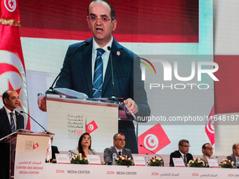 The head of the Tunisian election commission, Farouk Bouasker, along with other members of the Tunisian election commission, gives a press c...