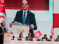 The head of the Tunisian election commission, Farouk Bouasker, along with other members of the Tunisian election commission, gives a press c...