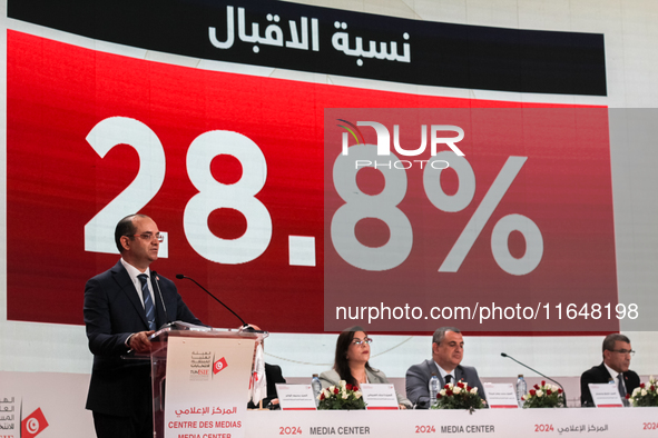 The head of the Tunisian election commission, Farouk Bouasker, along with other members of the Tunisian election commission, gives a press c...