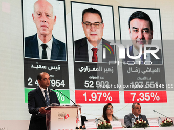 The head of the Tunisian election commission, Farouk Bouasker, along with other members of the Tunisian election commission, gives a press c...