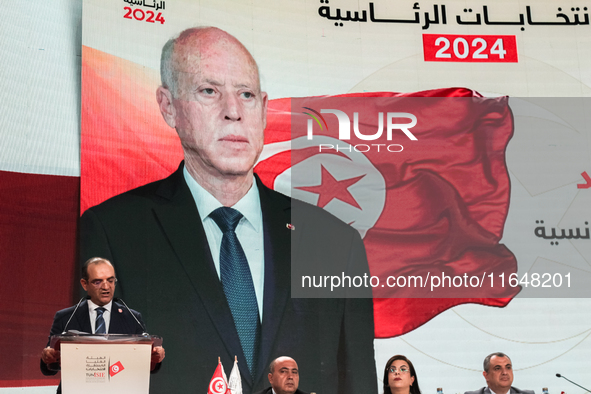 The head of the Tunisian election commission, Farouk Bouasker, along with other members of the Tunisian election commission, gives a press c...