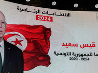 A giant screen displays a national flag of Tunisia with a portrait of Tunisia's president, Kais Saied, and the text in Arabic, ''Kais Saied...