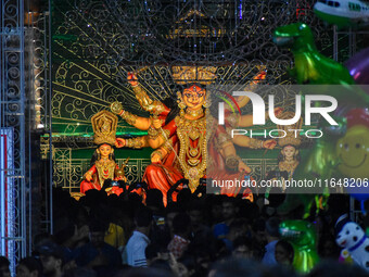 Devotees arrive to see an idol of Goddess Durga at a pandal during the Durga Puja celebration in Kolkata, India, on October 7, 2024. (