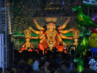 Devotees arrive to see an idol of Goddess Durga at a pandal during the Durga Puja celebration in Kolkata, India, on October 7, 2024. (