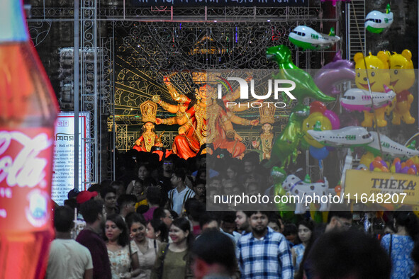 Devotees arrive to see an idol of Goddess Durga at a pandal during the Durga Puja celebration in Kolkata, India, on October 7, 2024. 