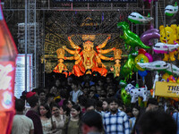 Devotees arrive to see an idol of Goddess Durga at a pandal during the Durga Puja celebration in Kolkata, India, on October 7, 2024. (