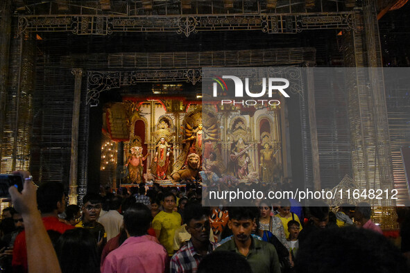 Devotees arrive to see an idol of Goddess Durga at a pandal during the Durga Puja celebration in Kolkata, India, on October 7, 2024. 